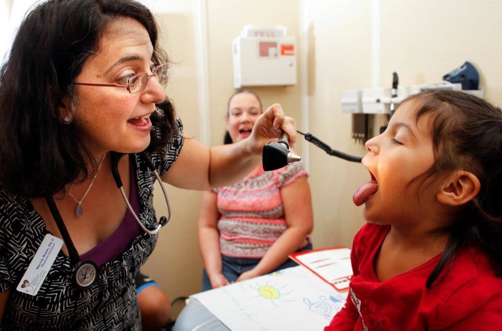 Doctor looking in child's mouth