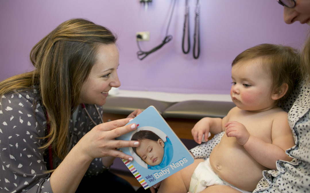 Doctor Showing Baby a Book